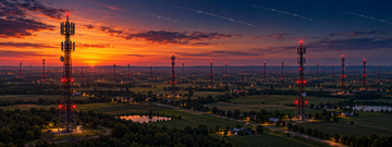 Aerial view of US cell towers and satellite constellation at dusk for Starlink Mobile talks