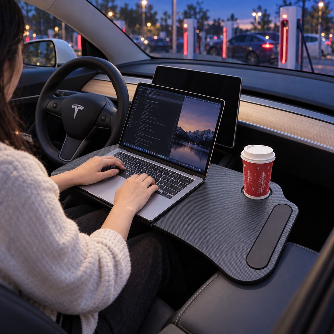 Foldable laptop desk holding a meal across the front cabin of a parked Tesla Model 3
