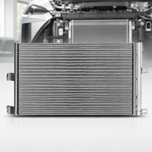 A silver metallic automotive radiator shown from the front, with a blurred background of a car engine bay.