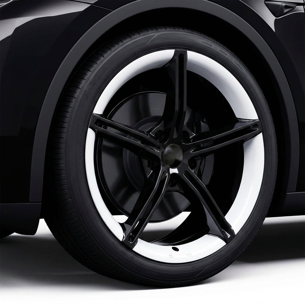 Close-up of a black car wheel with a white rim on a dark background
