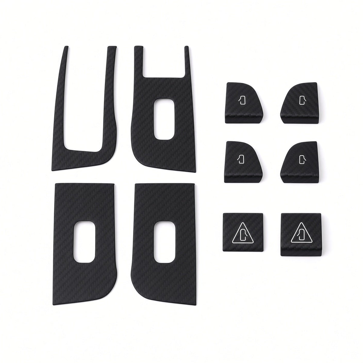 Ten dark carbon-weave covers laid out on white, showing four panel surrounds and six smaller door-control covers.