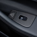 Carbon-weave surround around a single window switch and adjacent triangular door-release button on a black door panel.