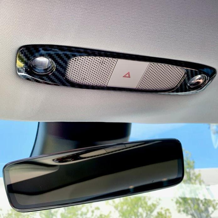 Glossy real carbon fiber dome light trim installed around the overhead lights and hazard control