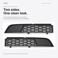 Mirror-image split grille halves with ribbed outer ends and shaped central contours.