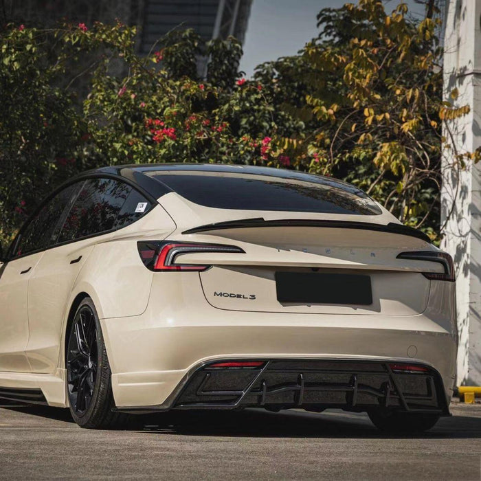 Three-quarter rear view of a Model 3 Highland with the carbon fiber spoiler installed
