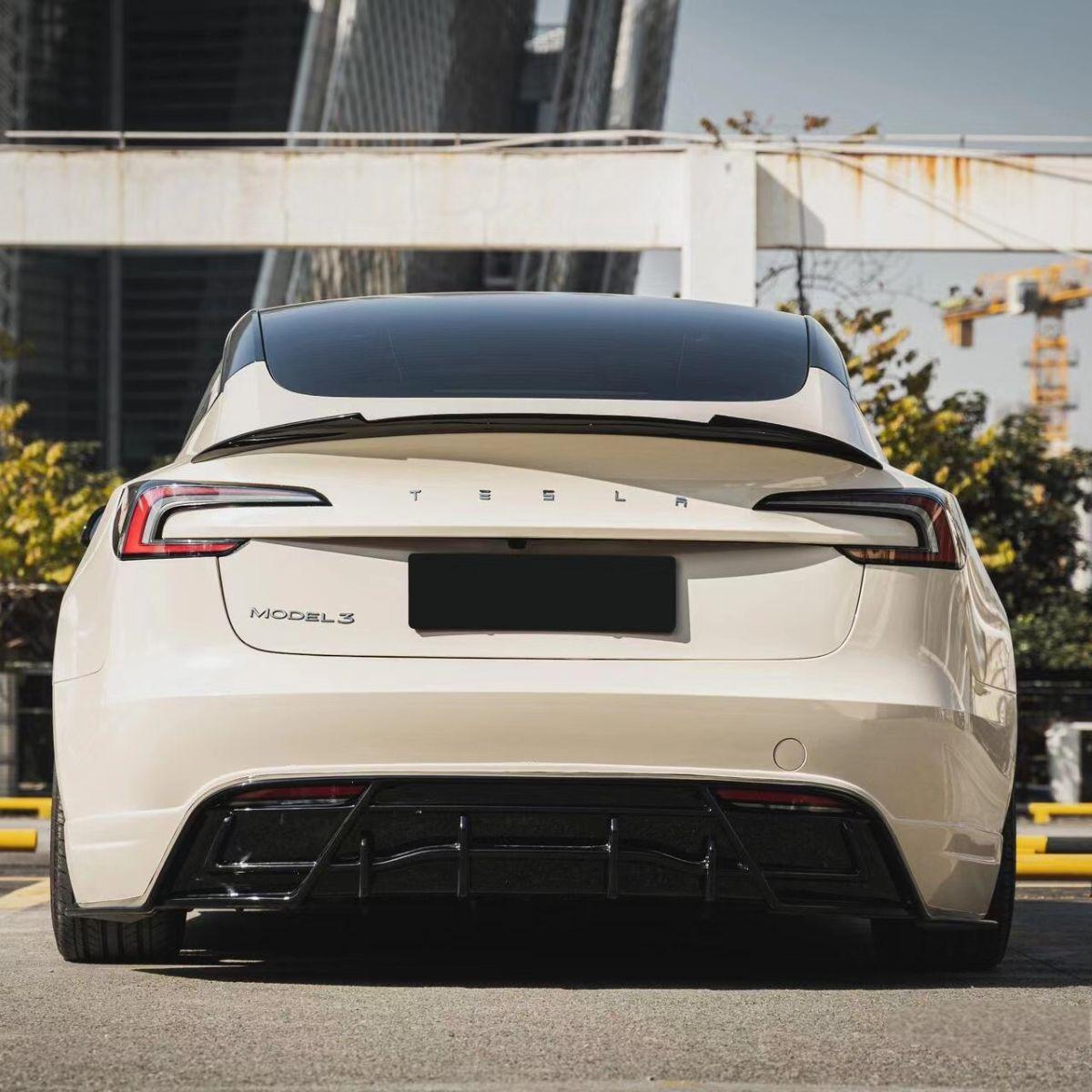 Rear view of a Tesla Model 3 Highland fitted with a carbon fiber trunk spoiler