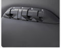 Angled close-up of a TESERY seat-back organizer installed in a Tesla, with several hooks open.