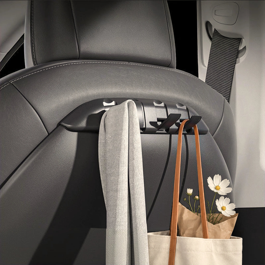 TESERY seat-back hook organizer in a Tesla Model 3/Y, holding a tote bag and scarf behind the front seat.