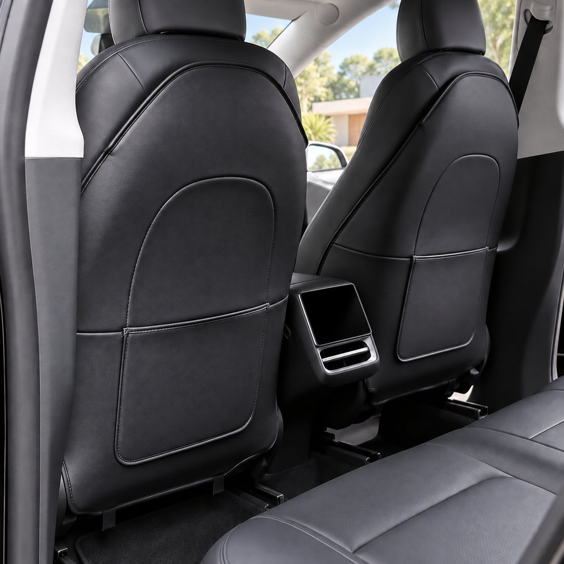 Two black single-pocket PU seat back protectors for Tesla Model 3 Highland and Model Y Juniper on a pure white background.