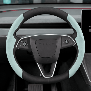Light blue Alcantara grip covers fitted to both sides of a Tesla steering wheel